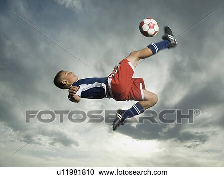 Low angle view of soccer player jumping View Large Photo Image Stock Image - Low angle view of soccer player jumping. Fotosearch