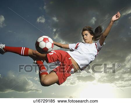 Stock Photography - Low angle view of soccer player jumping. Fotosearch