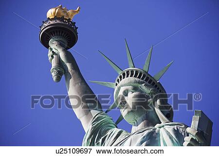Stock Photo - Low angle view of the Statue of Liberty. Fotosearch