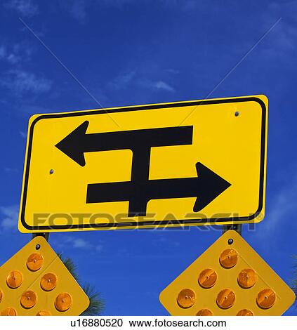 Stock Image - Low angle view of traffic direction sign. Fotosearch