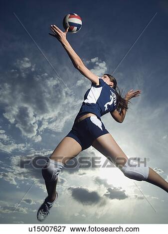 Low angle view of volleyball player jumping View Large Photo Image Stock Photo - Low angle view of volleyball player jumping. Fotosearch