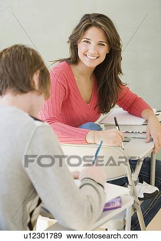 Male and female college students in classroom View Large Photo Image Stock Photo - Male and female college students in classroom. Fotosearch