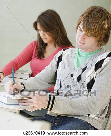 Male and female college students in classroom View Large Photo Image Stock Photo - Male and female college students in classroom. Fotosearch
