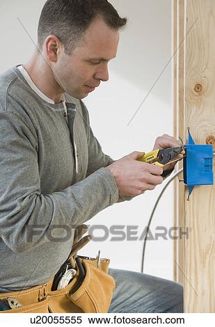 Male electrician cutting wire View Large Photo Image Stock Photography - Male electrician cutting wire. Fotosearch