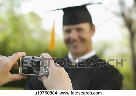 Male graduate having photograph taken View Large Photo Image Picture - Male graduate having photograph taken. Fotosearch