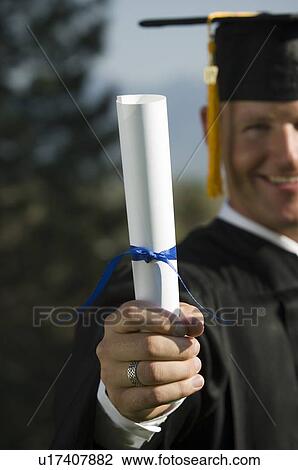 Male graduate holding diploma View Large Photo Image Stock Image - Male graduate holding diploma. Fotosearch