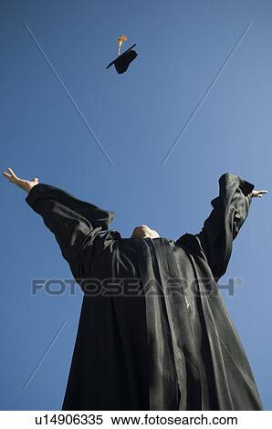 Male graduate throwing cap in air View Large Photo Image Stock Photography - Male graduate throwing cap in air. Fotosearch