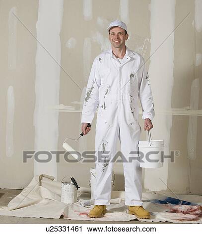 Male painter holding paint roller and paint can View Large Photo Image Stock Image - Male painter holding paint roller and paint can. Fotosearch