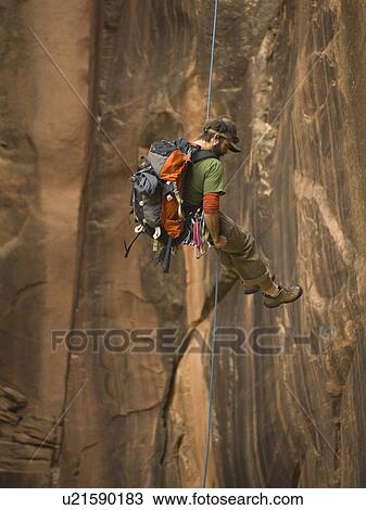 Man canyon rappelling View Large Photo Image Stock Image - Man canyon rappelling. Fotosearch