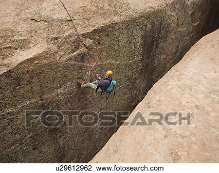 Man canyon rappelling View Large Photo Image Stock Image - Man canyon rappelling. Fotosearch