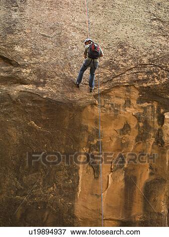 Man canyon rappelling View Large Photo Image Stock Photo - Man canyon rappelling. Fotosearch