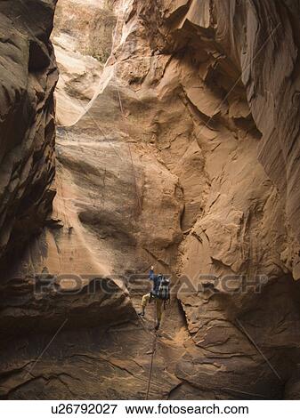 Stock Photo - Man canyon rappelling. Fotosearch