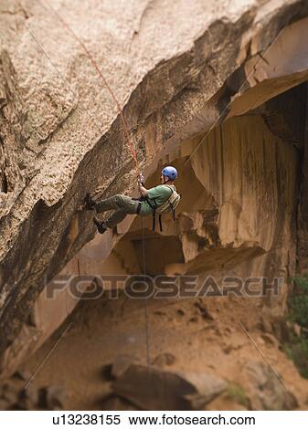 Man canyon rappelling View Large Photo Image Stock Photography - Man canyon rappelling. Fotosearch