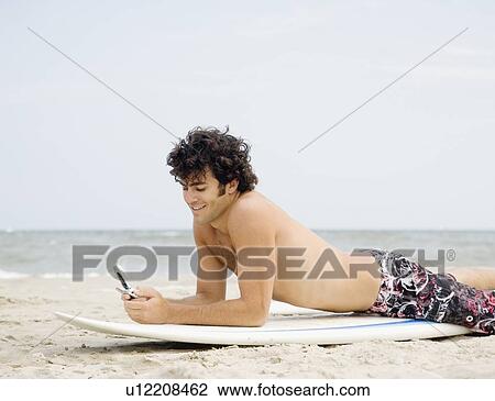 Stock Image - Man dialing cell phone. Fotosearch