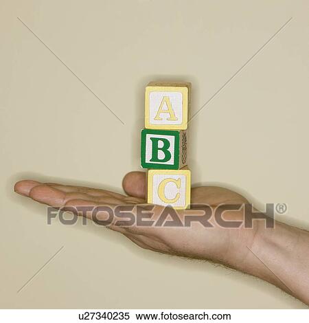 Stock Photography - Man holding ABC blocks. Fotosearch