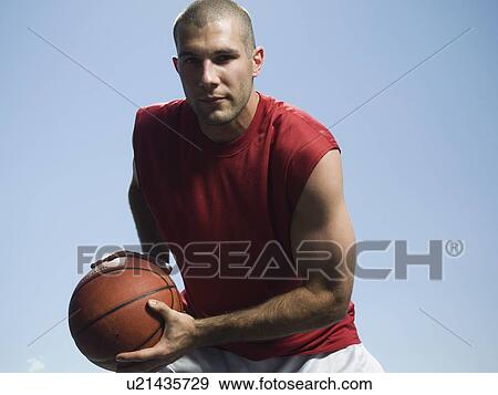 Man holding basketball View Large Photo Image Stock Photo - Man holding basketball. Fotosearch
