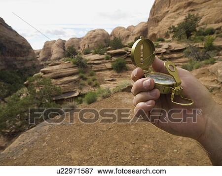 Man holding compass View Large Photo Image Stock Photo - Man holding compass. Fotosearch