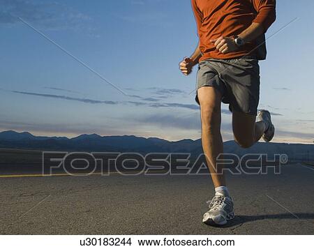 Picture - Man in athletic gear running. Fotosearch