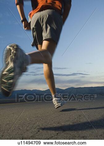 Stock Photo - Man in athletic gear running. Fotosearch