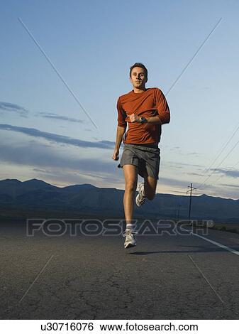 Stock Photograph - Man in athletic gear running. Fotosearch