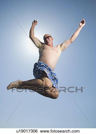 Man in bathing suit jumping View Large Photo Image Stock Photograph - Man in bathing suit jumping. Fotosearch