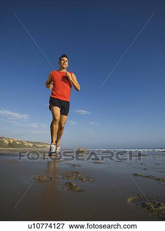 Man jogging on beach View Large Photo Image Stock Photo - Man jogging on beach. Fotosearch