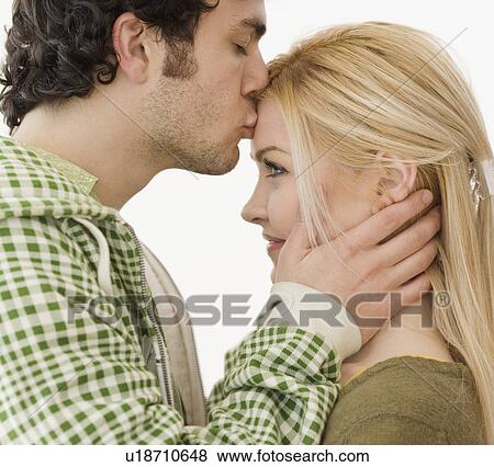 Man kissing girlfriend on forehead View Large Photo Image Stock Photo - Man kissing girlfriend on forehead. Fotosearch
