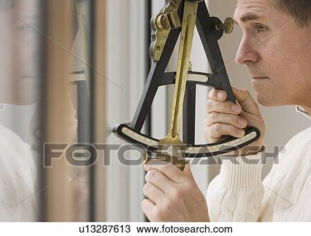 Man measuring angle with sextant View Large Photo Image Stock Image - Man measuring angle with sextant. Fotosearch