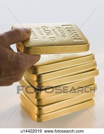 Man picking up gold bar View Large Photo Image Stock Photo - Man picking up gold bar. Fotosearch