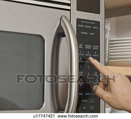 Man pushing button on microwave View Large Photo Image Stock Image - Man pushing button on microwave. Fotosearch