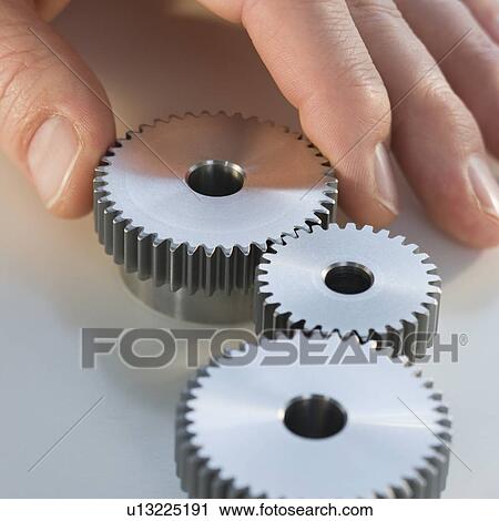 Man reaching for cog wheels View Large Photo Image Stock Image - Man reaching for cog wheels. Fotosearch