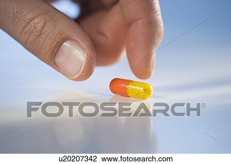 Stock Image - Man reaching for medication. Fotosearch