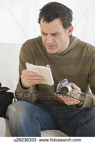 Man reading camera manual View Large Photo Image Stock Image - Man reading camera manual. Fotosearch
