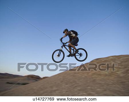 Stock Photo - Man riding mountain bike. Fotosearch