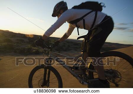 Stock Photo - Man riding mountain bike. Fotosearch