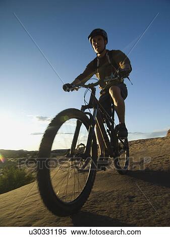 Stock Photography - Man riding mountain bike. Fotosearch