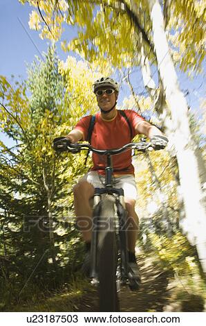 Stock Image - Man riding mountain bike, Utah, United States. Fotosearch