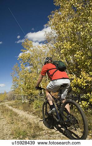 Man riding mountain bike, Utah, United States View Large Photo Image Stock Photo - Man riding mountain bike, Utah, United States. Fotosearch