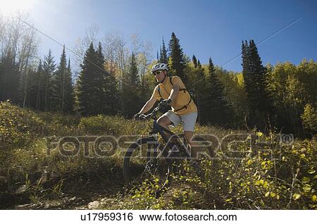 Man riding mountain bike, Utah, United States View Large Photo Image Stock Photograph - Man riding mountain bike, Utah, United States. Fotosearch