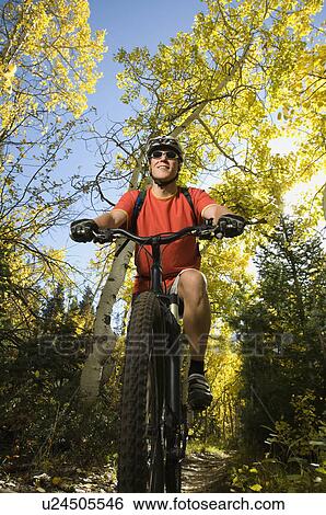 Man riding mountain bike, Utah, United States View Large Photo Image Stock Photograph - Man riding mountain bike, Utah, United States. Fotosearch