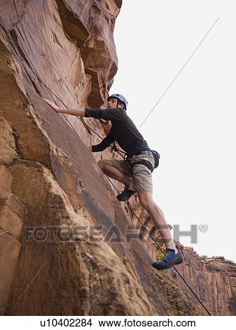 Picture - Man rock climbing. Fotosearch