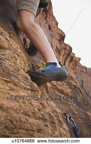 Stock Photo - Man rock climbing. Fotosearch