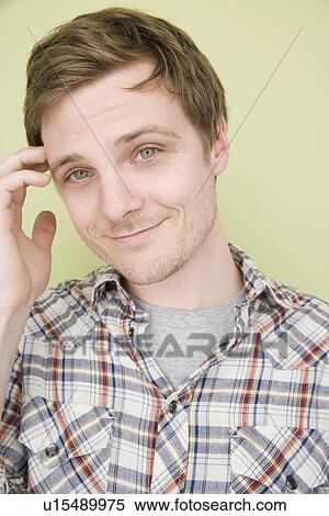 Stock Photography - Man scratching temple. Fotosearch