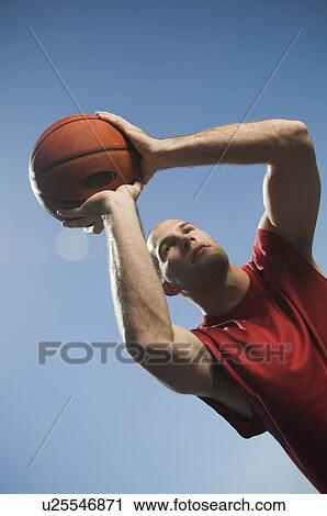 Stock Image - Man shooting basketball. Fotosearch
