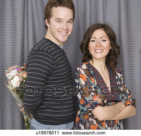 Man surprising girlfriend with flowers View Large Photo Image Stock Image - Man surprising girlfriend with flowers. Fotosearch