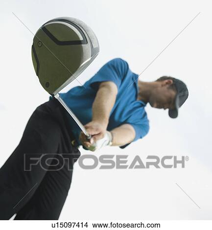 Picture - Man swinging golf club. Fotosearch