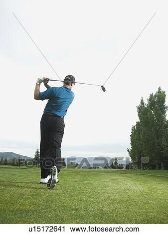 Man swinging golf club View Large Photo Image Stock Image - Man swinging golf club. Fotosearch