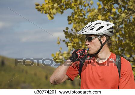 Man wearing bicycle helmet, Utah, United States View Large Photo Image Stock Image - Man wearing bicycle helmet, Utah, United States. Fotosearch