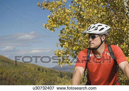 Stock Photo - Man wearing bicycle helmet, Utah, United States. Fotosearch