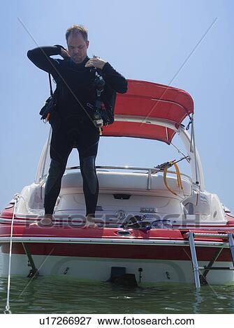 Man with scuba gear on boat, Florida, United States View Large Photo Image Stock Photo - Man with scuba gear on boat, Florida, United States. Fotosearch